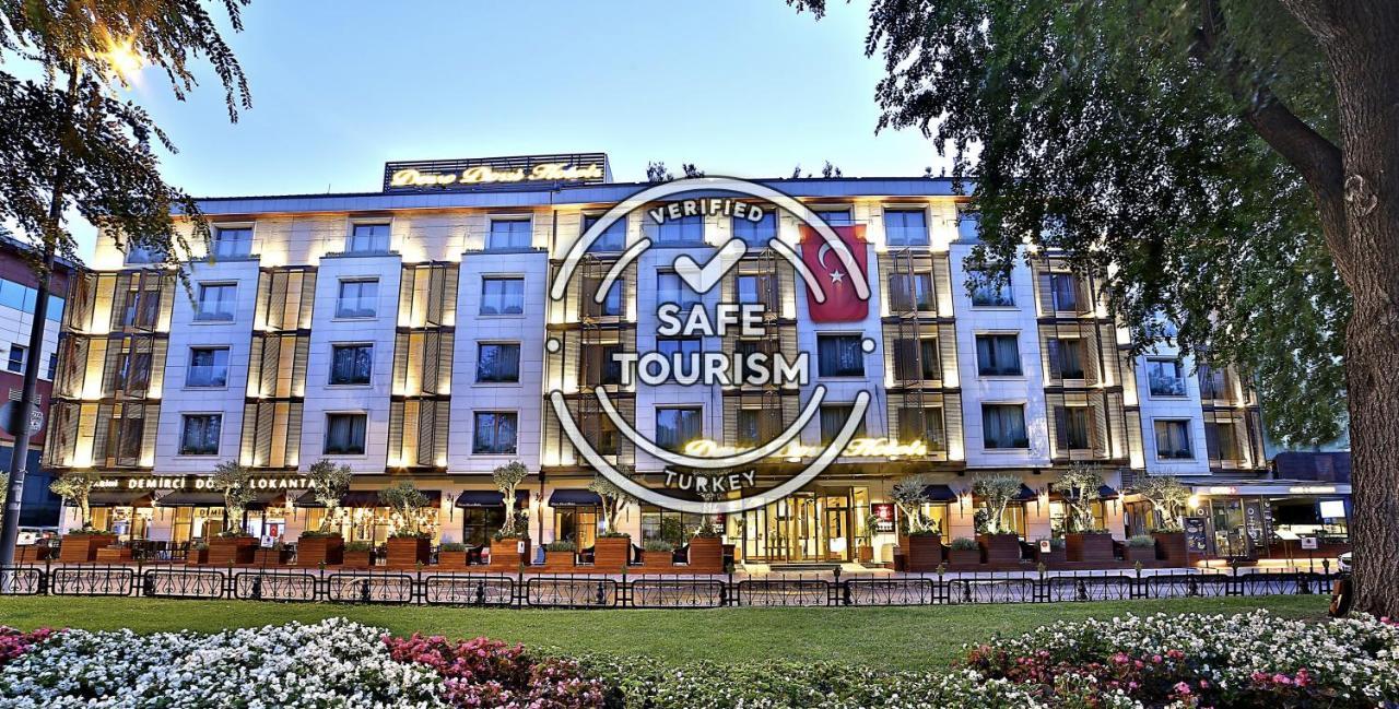 Dosso Dossi Hotels & Spa Downtown Istambul Exterior foto The photo shows a modern hotel building, prominently featuring a well-lit façade. In front of the hotel, there are landscaped gardens with colorful flowers. Overlaying the image is a "Verified Safe Tourism" badge, indicating that the location meets c