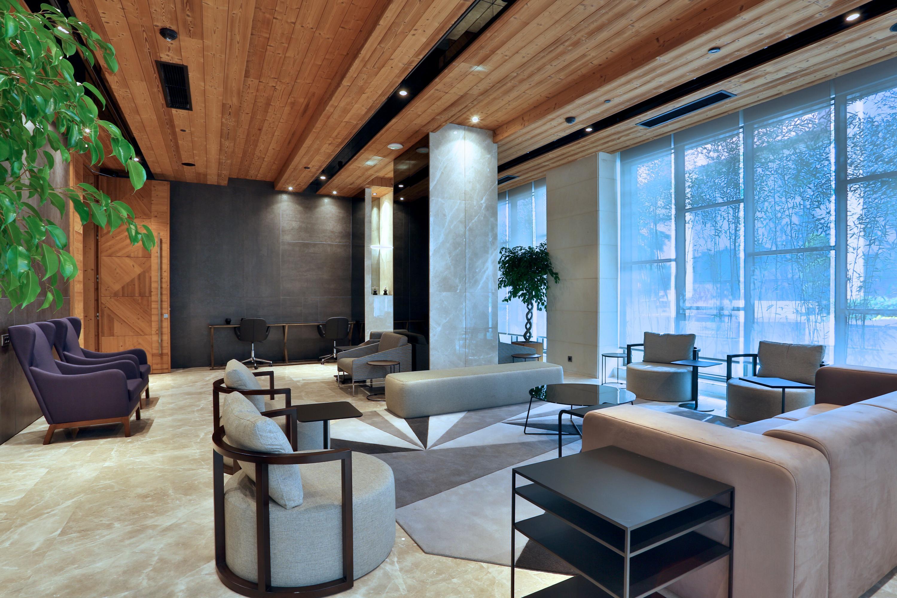 Dosso Dossi Hotels & Spa Downtown Istambul Exterior foto The photo depicts a modern, elegantly designed lounge area. The space features a combination of light hardwood and darker elements on the walls, creating a warm and inviting atmosphere. In the center, there are several seating options, including styl